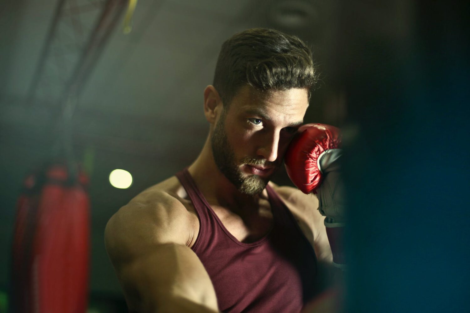 close up photography of man wearing boxing gloves